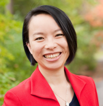 A headshot of Debbie Chang. Debbie is wearing a red blazer.