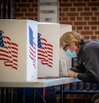 Voter fills out ballot at polling place 